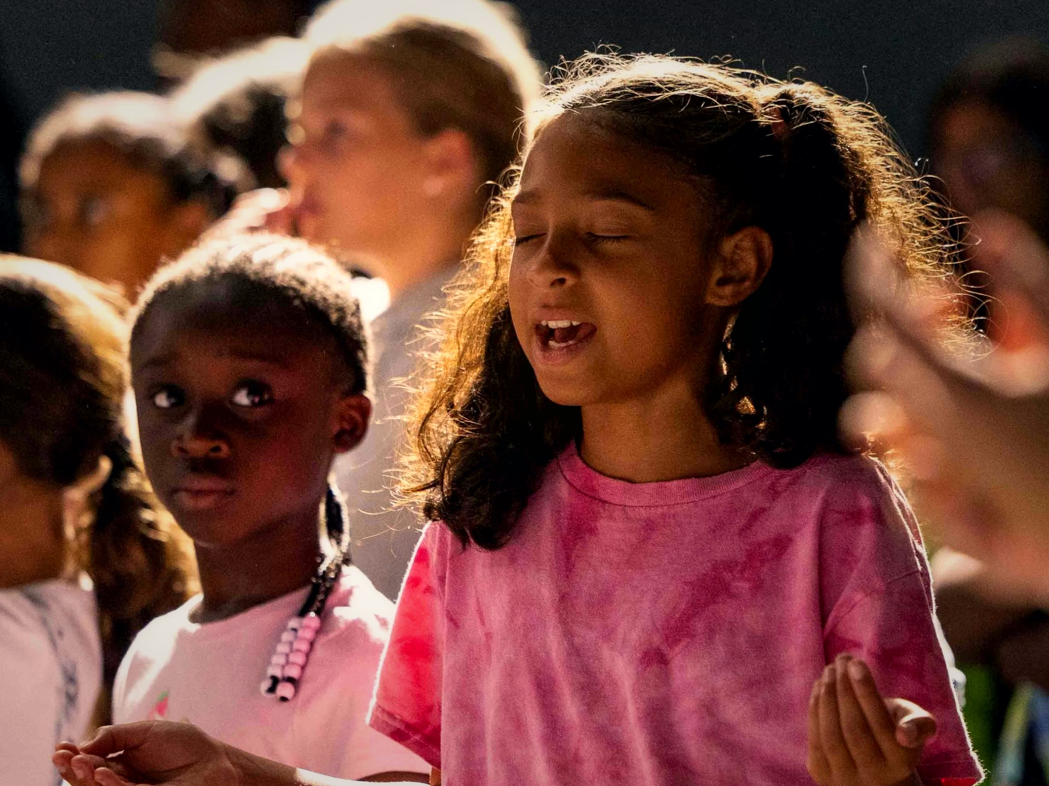 A child worshiping at Kids Conference